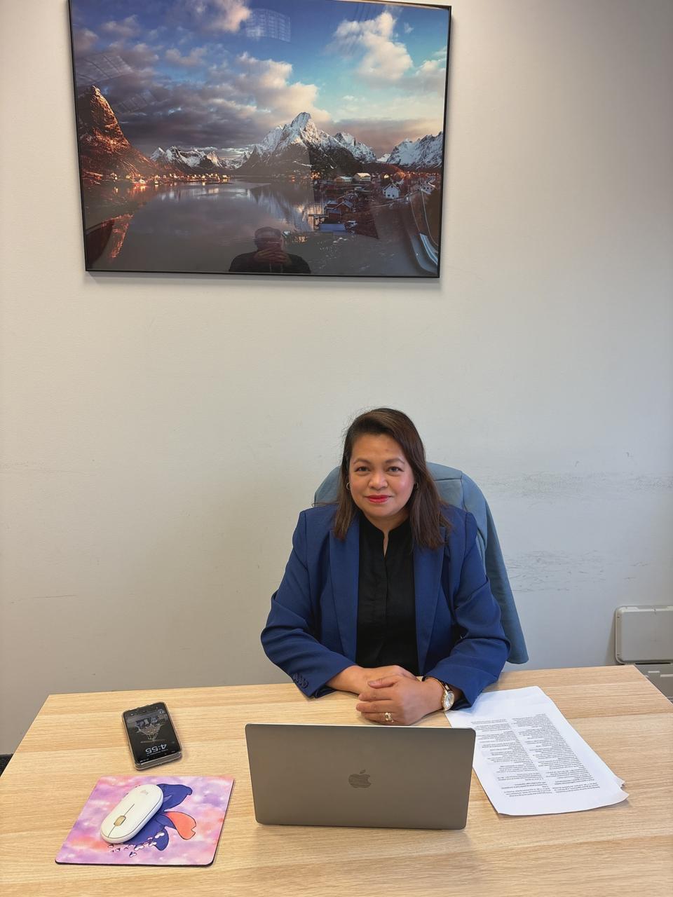 Portrait of the MiraiLink chief executive seated at a desk in an office